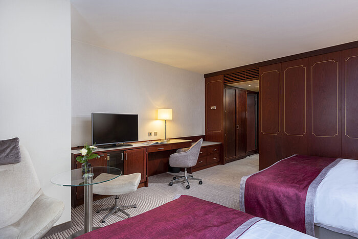 Familienzimmer im Maritim Hotel Bonn mit modernen Annehmlichkeiten, komfortablen Betten und einem praktischen Schreibtisch.