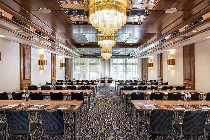 Stilvoller Tagungsraum mit großen Kronleuchtern, Tageslicht und moderner Bestuhlung im Maritim Hotel Königswinter.