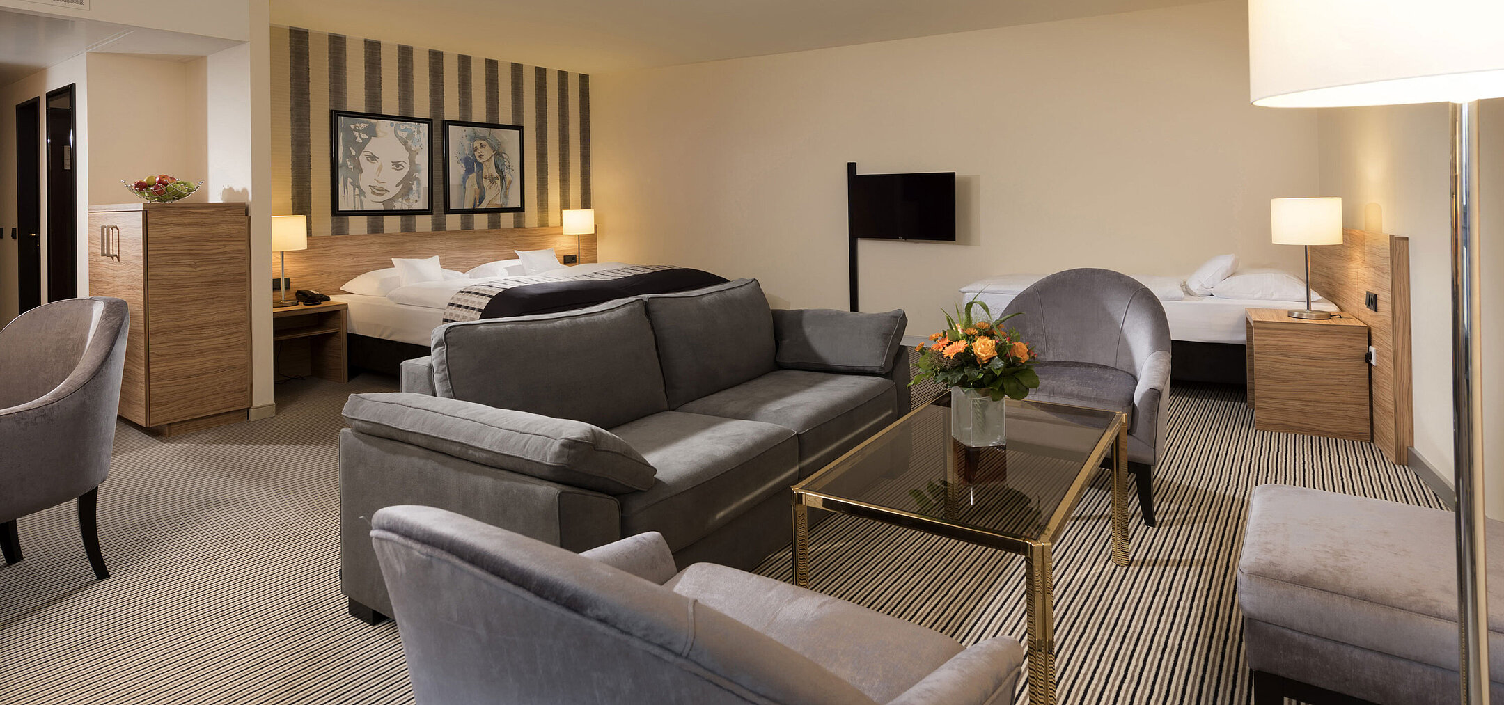 Geräumige Suite im Maritim Hotel Königswinter mit gemütlicher Sitzecke und stilvollem Design.