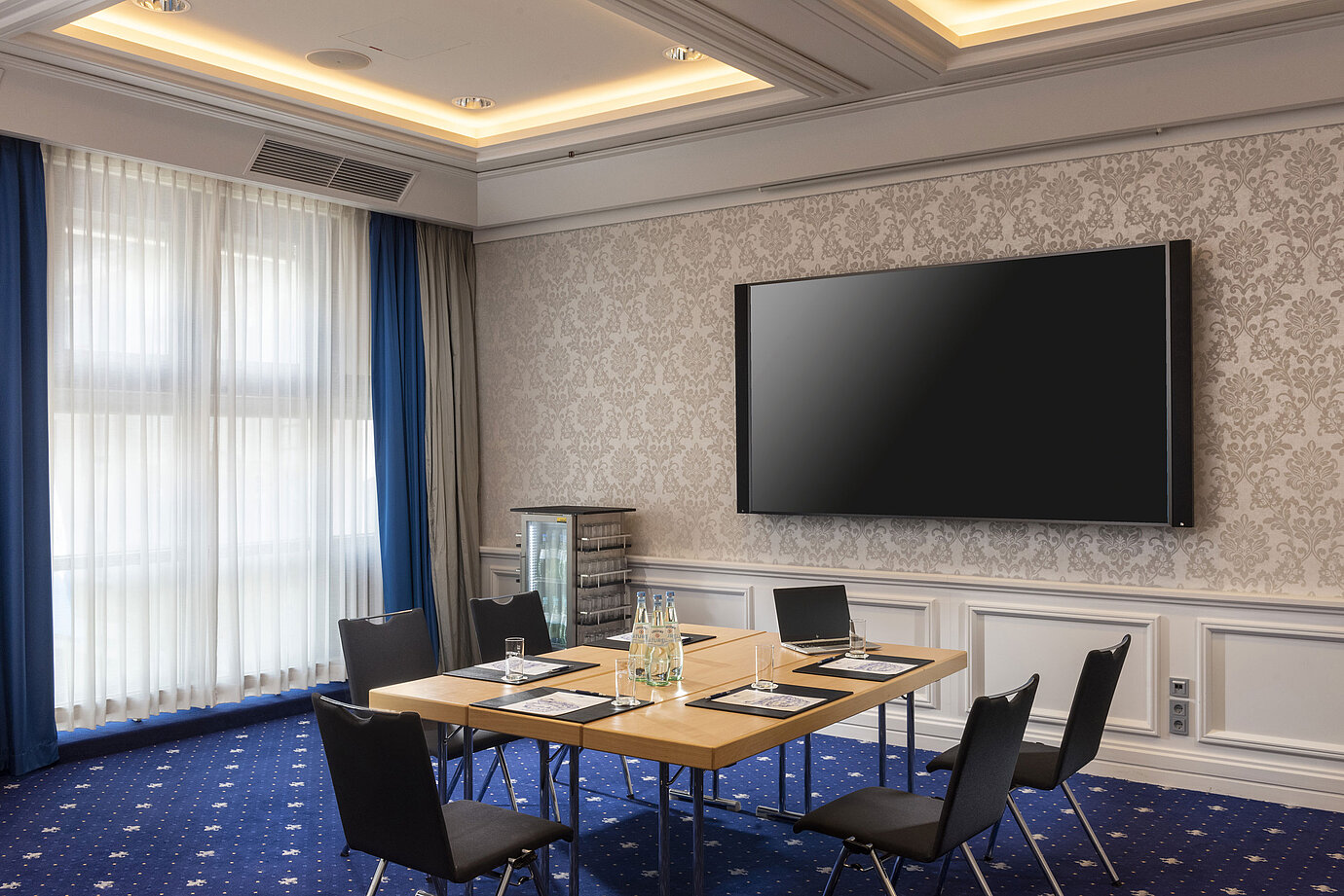Tagungsraum im Maritim Hotel Würzburg mit moderner Ausstattung und großem Bildschirm.