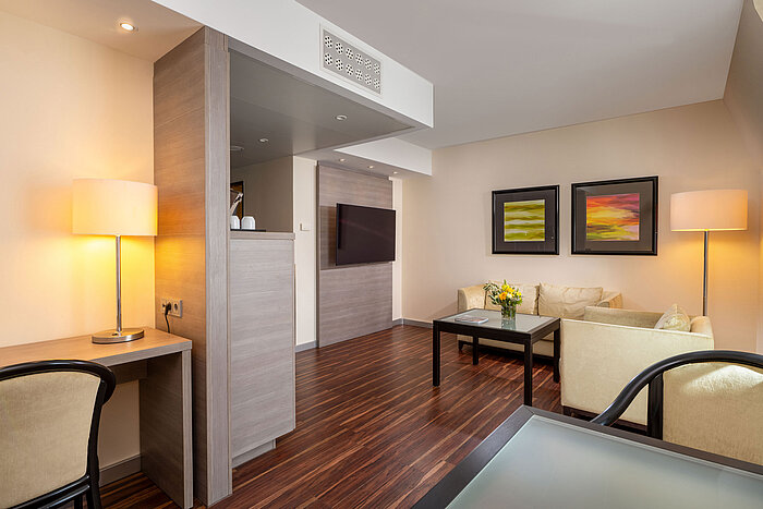 Junior Suite Junior Suite im Maritim Hotel Königswinter mit Wohnbereich, Sitzgruppe, Schreibtisch und offenem Raumkonzept.