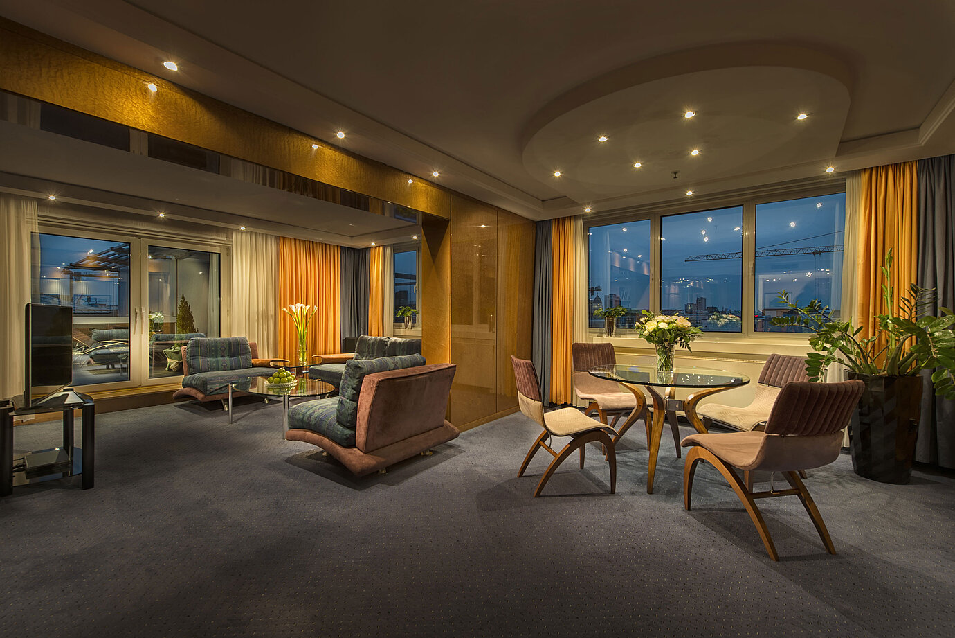 Elegantes Wohnzimmer in der Präsidenten-Suite im Maritim proArte Hotel Berlin mit stilvoller Beleuchtung und Aussicht.