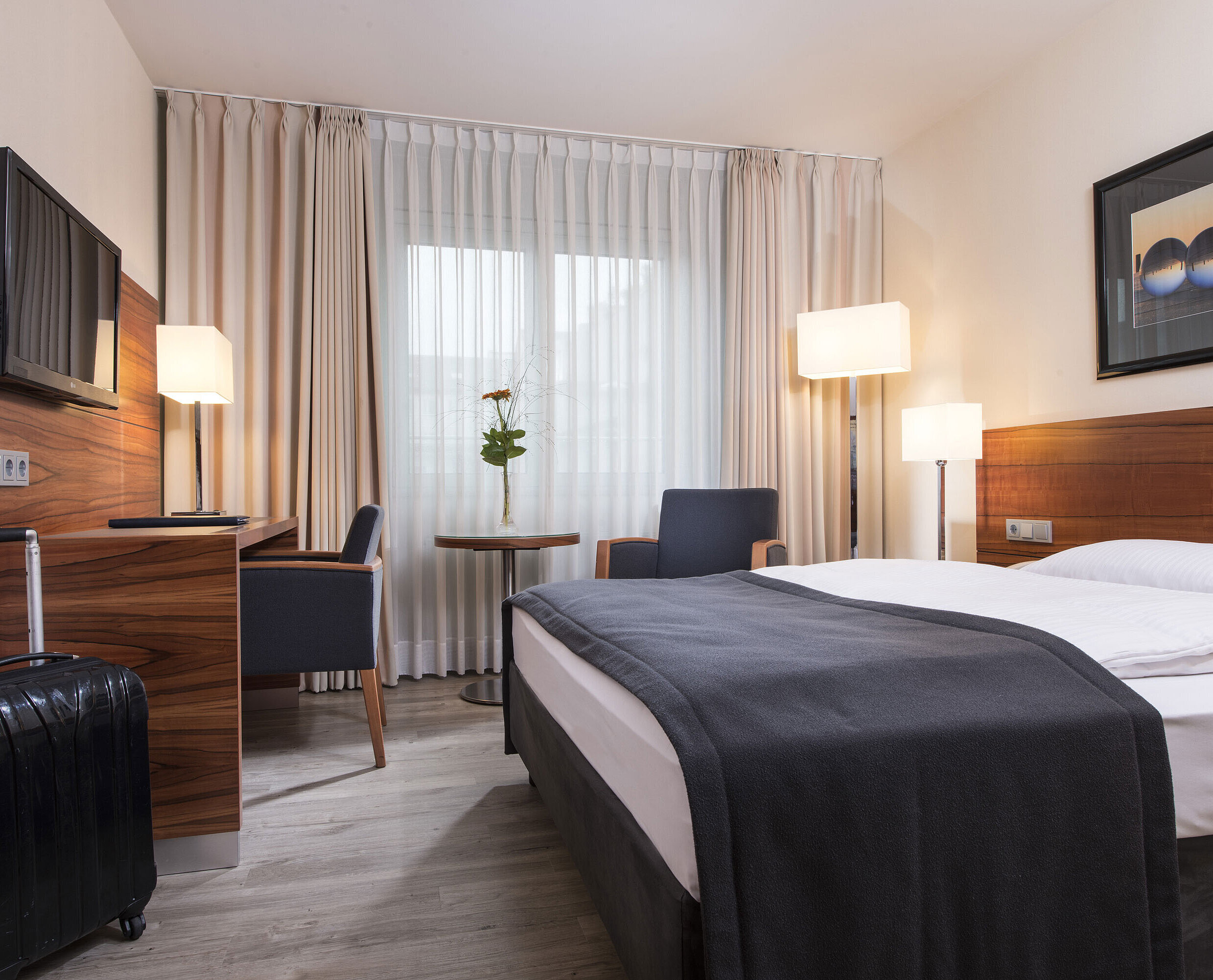 Allergikerzimmer Gemütliches Zimmer mit Doppelbett, Schreibtisch und Koffer im Maritim Hotel München