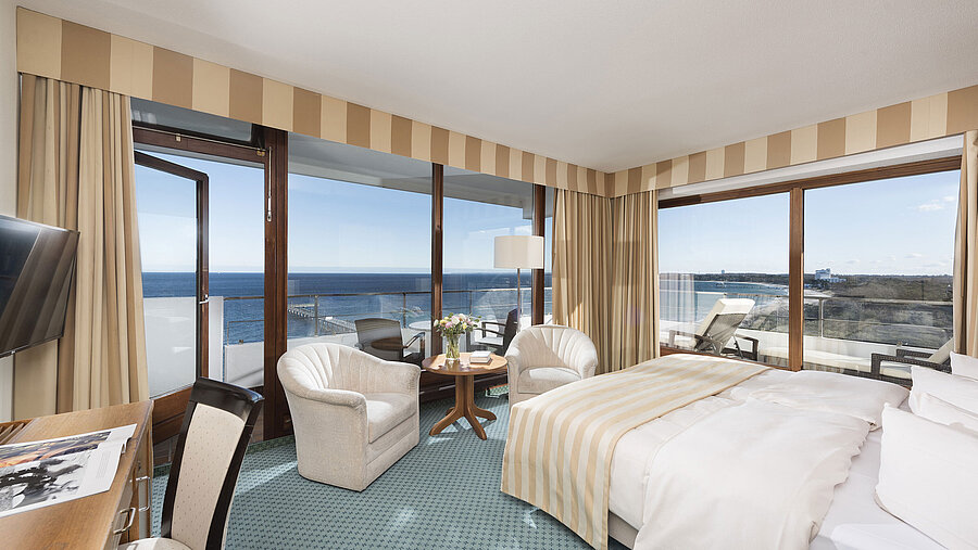 Superior Zimmer im Maritim Seehotel Timmendorfer Strand mit Meerblick, Balkon, Sitzbereich und großem Bett.