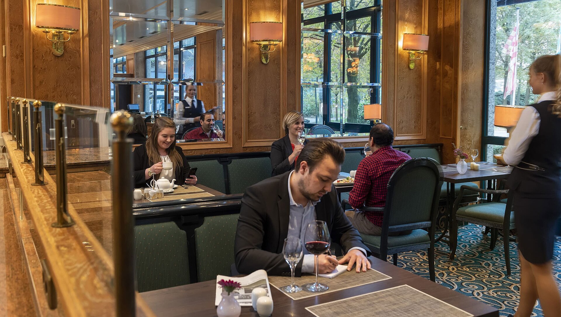 Gäste genießen ihr Essen und entspannen in der Brasserie des Maritim Bremen mit freundlichem Service und stilvoller Atmosphäre
