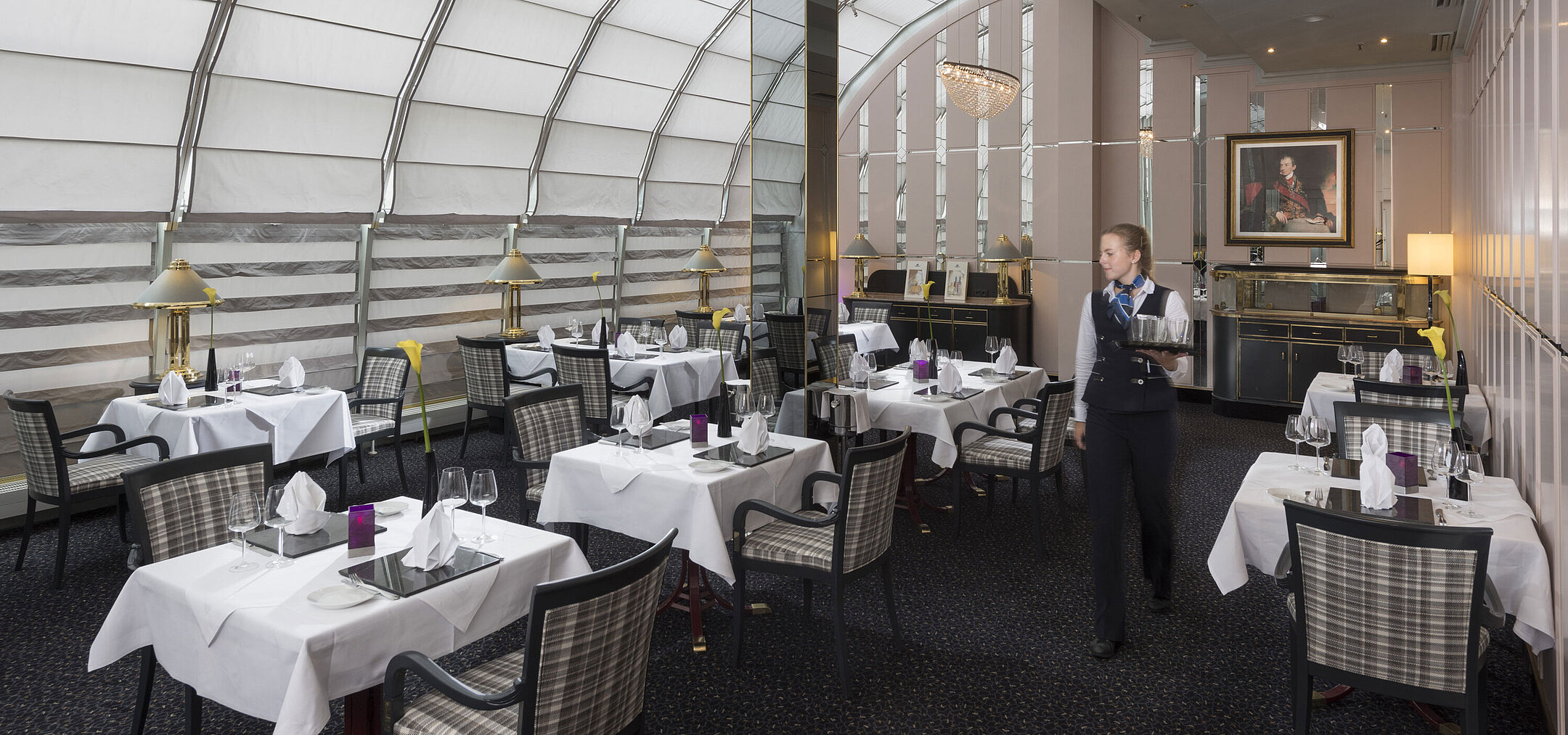 Helles Restaurant mit Servicekraft und stilvoller Einrichtung im Maritim Hotel München